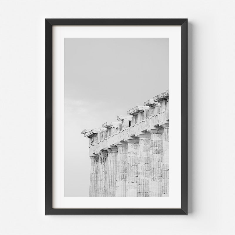 Framed black and white photograph of ancient columns on a light gray background