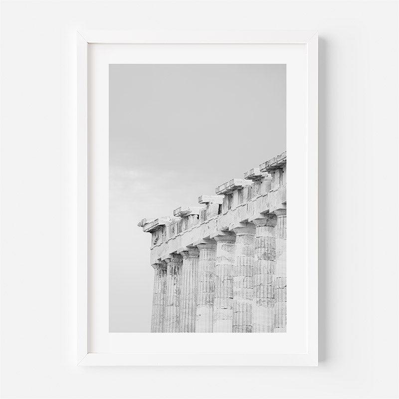 Framed black and white photograph of ancient columns on a light gray background