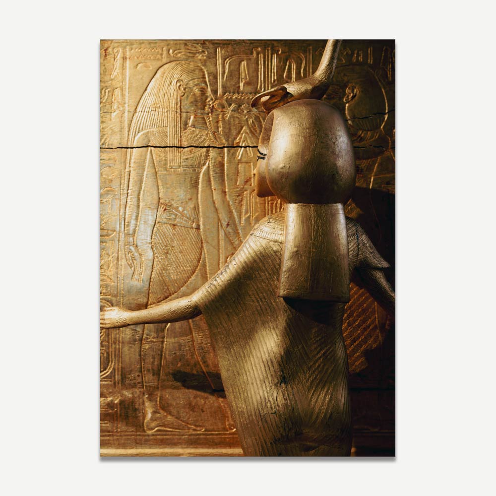 A photograph of a golden statue of the goddess Serket, which is a replica of an ancient Egyptian figure, displaying intricate details and a radiant golden finish.