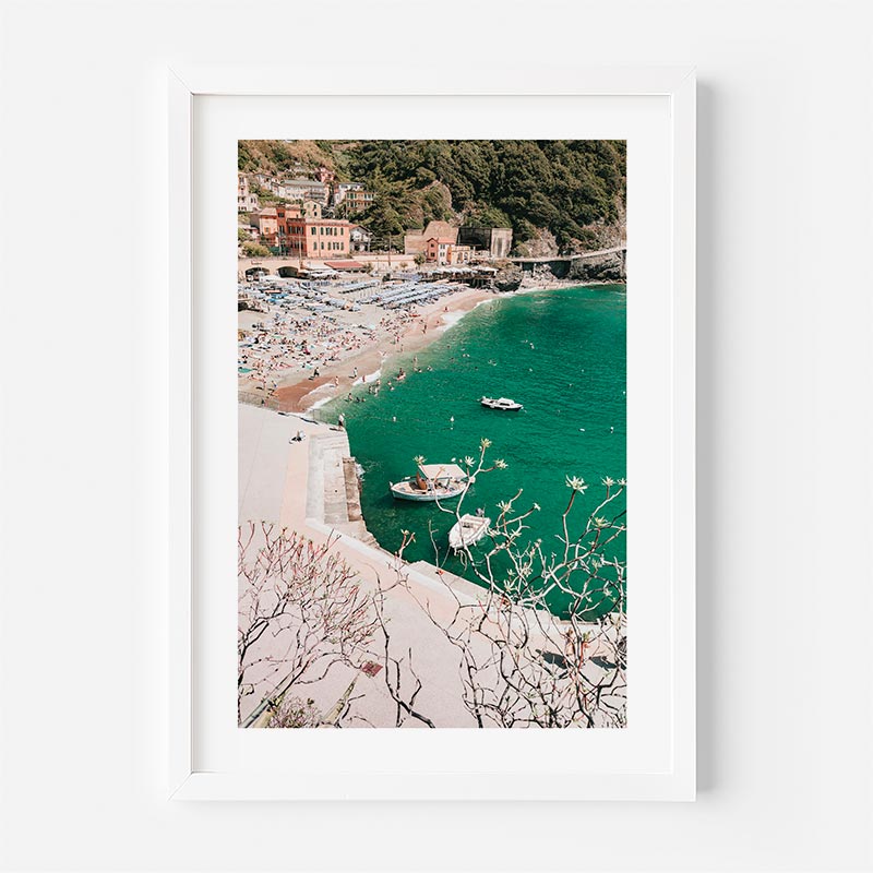 Framed photograph of a coastal scene with boats and buildings.
