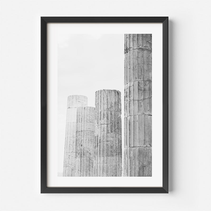 Framed black and white artwork of textured columns on a white background