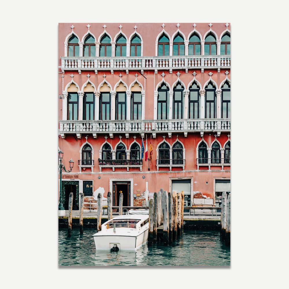 Venice taxi boat docking in front of pink building with white windows – sophisticated canal scene for Venetian-inspired home decor.