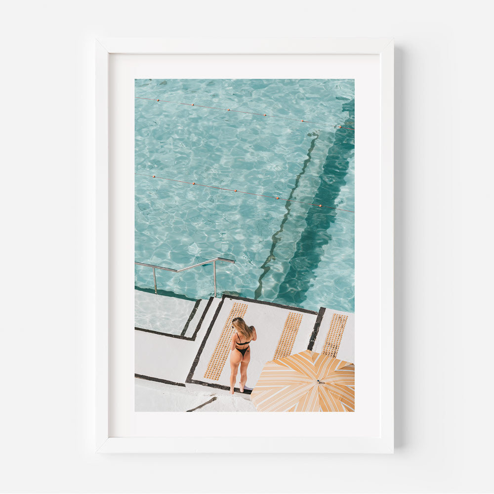 Swimmer at Bondi Icebergs ocean pool, surrounded by refreshing turquoise and green hues.
