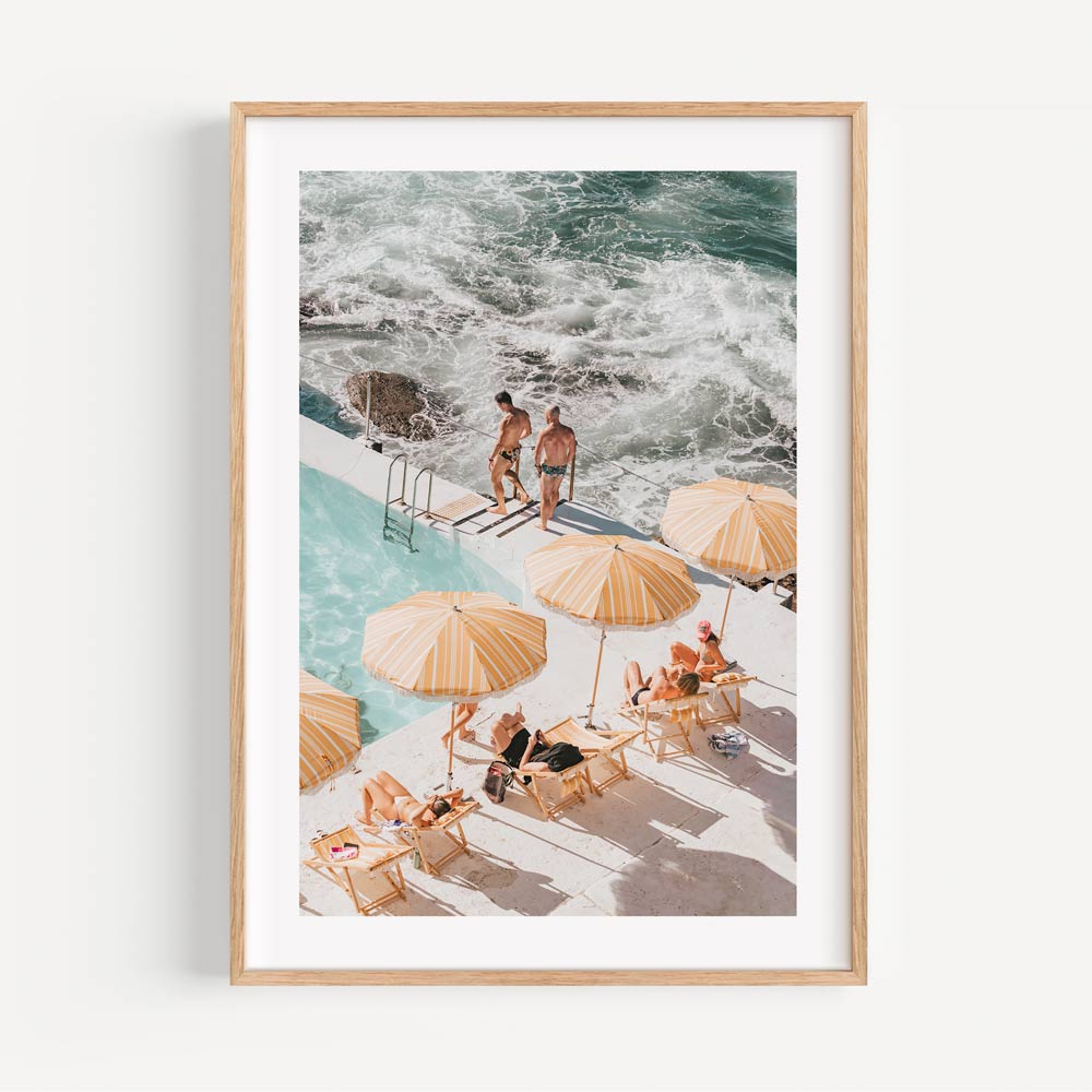 Coastal wall art capturing Bondi Icebergs pool, refreshing ocean hues, and vibrant umbrellas for a bright home decor.