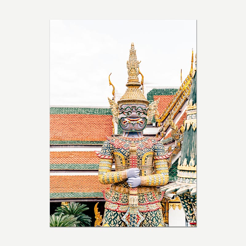 A vertical art print depicting a colorful Thai temple guardian statue in front of ornate traditional rooftops, shown against a light gray background.