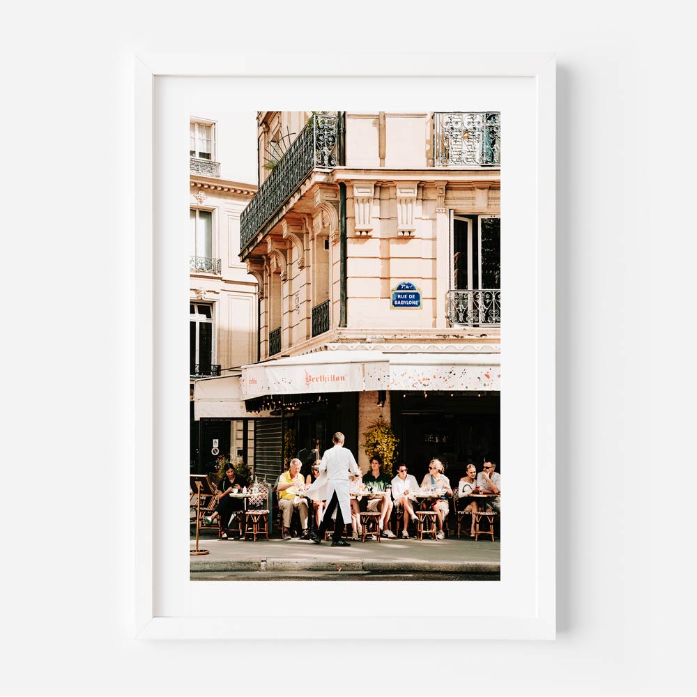 Eiffel Tower seen from Rue Saint-Dominique, framed by Parisian buildings and vibrant cafés, offering a picturesque Paris view.