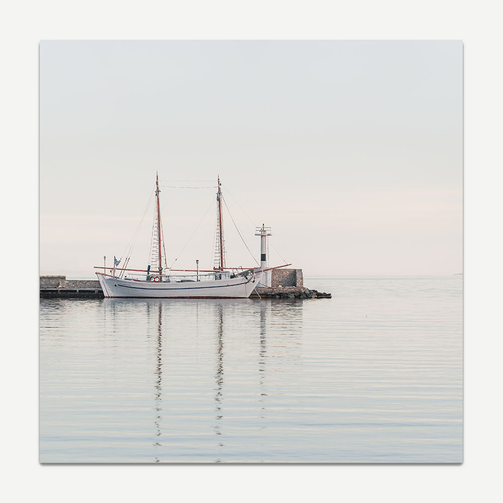 Sailing boat reflected in calm sunrise waters at Mykonos Old Port – coastal wall art print