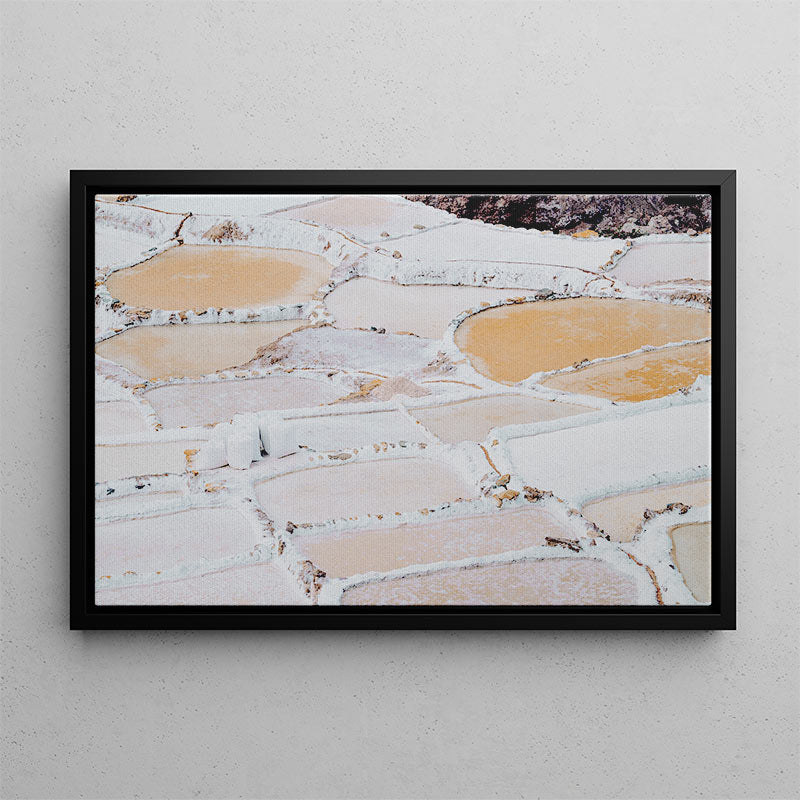Framed photograph of a natural landscape with geometric patterns on a gray wall.