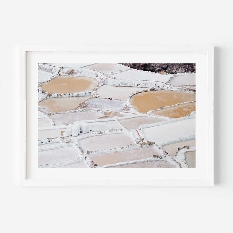 Framed photograph of salt pans with white and brown patterns