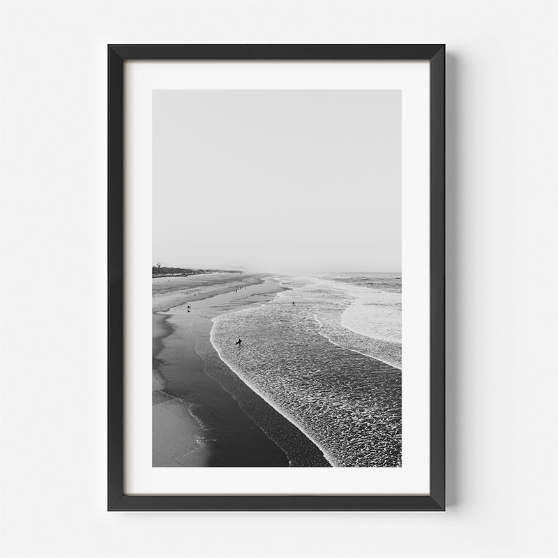 Framed black and white beach print on a white wall