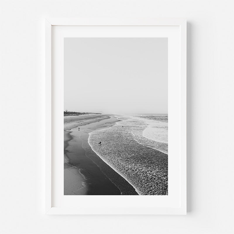 Framed black and white beach print on a white wall