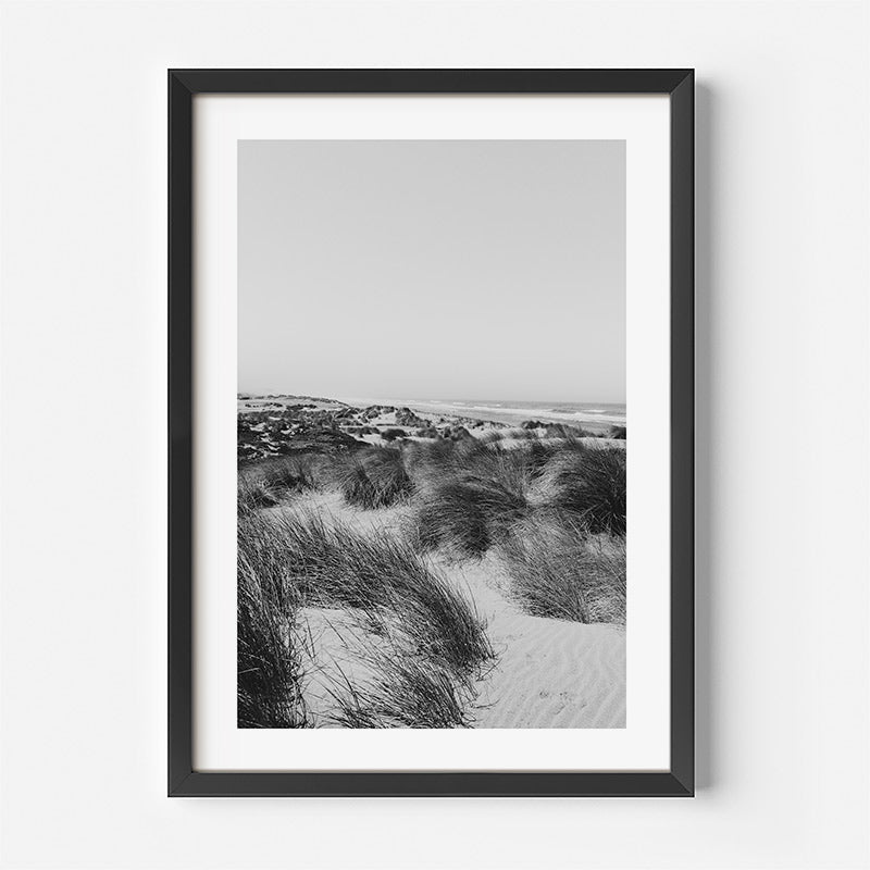 Framed black and white photograph of a beach scene with sand dunes.