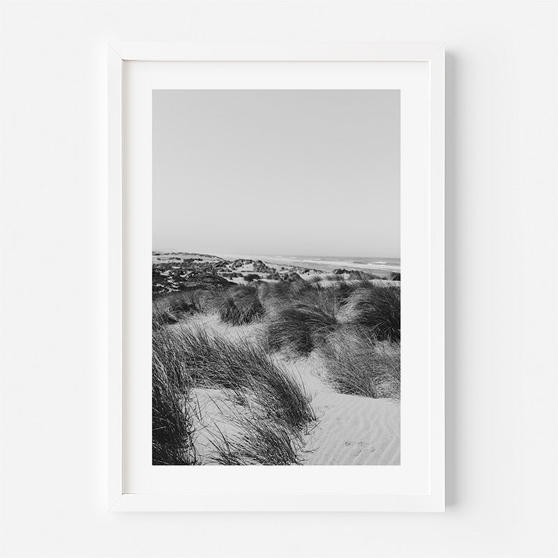 Framed black and white photograph of a beach scene with sand dunes.