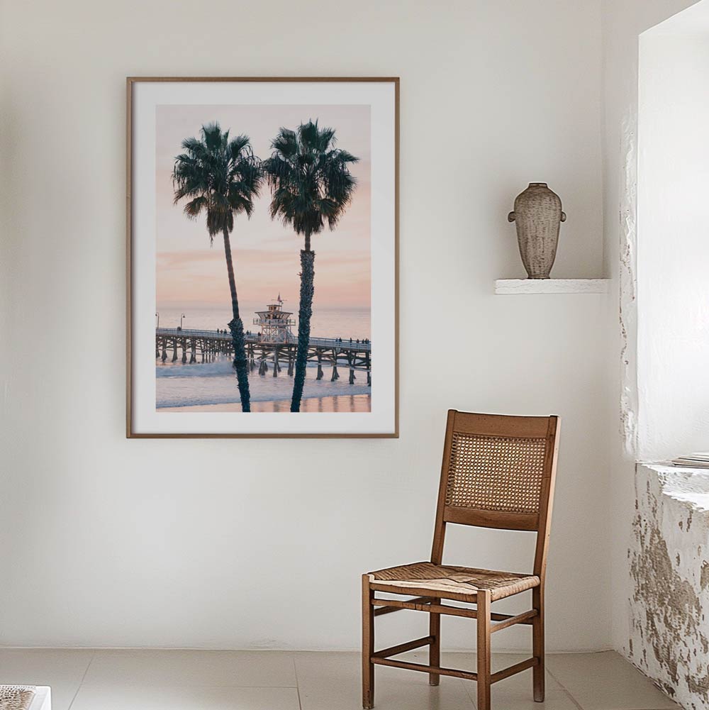 Original coastal wall art featuring San Clemente Pier at dusk with a glowing pink sky, photographed by Seus Ku on Thanksgiving Day.