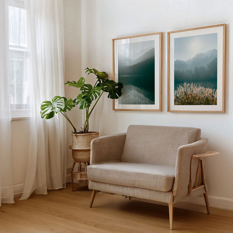 Beige armchair in a room with two framed landscape pictures on the wall.
