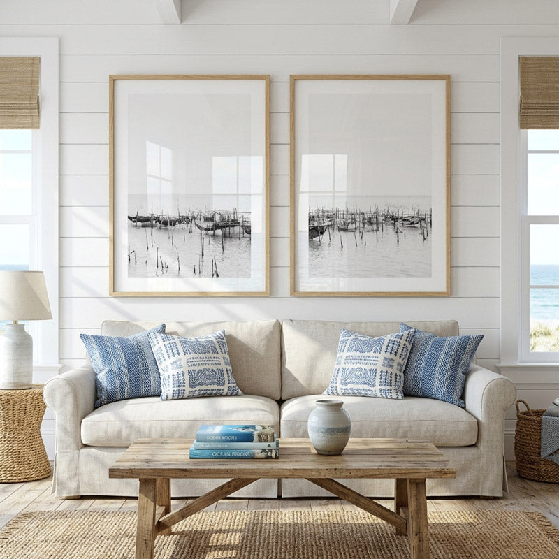 Living room with beige sofa, wooden coffee table, and framed artwork on a white wall.
