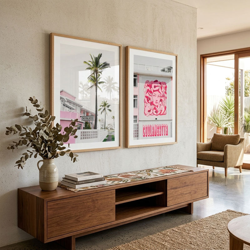Modern living room with wooden console table, framed artwork, and decorative elements.