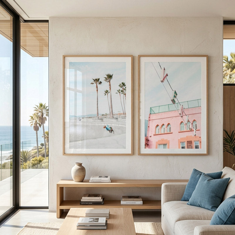 Modern living room with framed artwork, a vase, and a sofa.