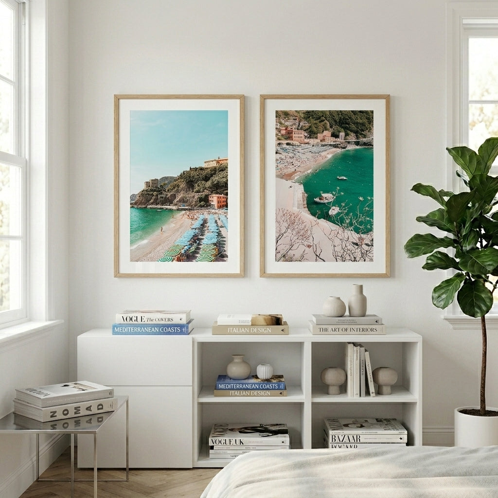 Living room with framed coastal prints on the wall, books on a shelf, and a plant.