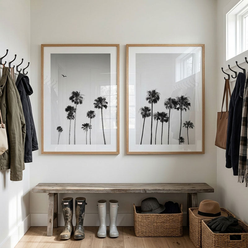 Entryway with framed palm tree prints, wooden bench, and storage baskets.