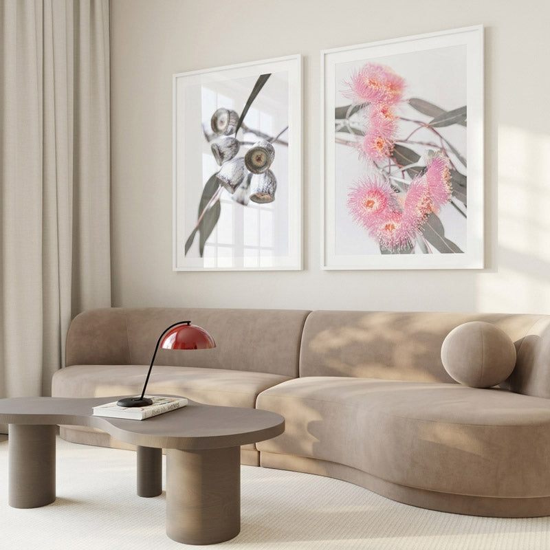 Modern living room with a beige sofa, coffee table, and floral artwork on the wall.