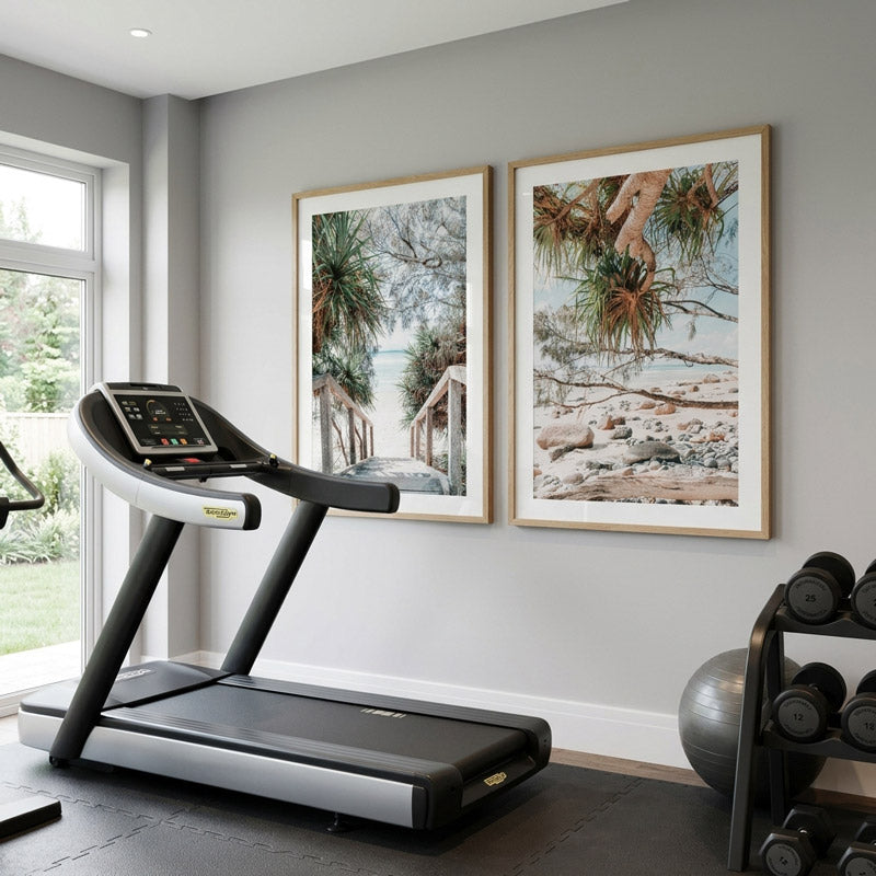 Treadmill in a modern home gym with framed artwork on the wall.