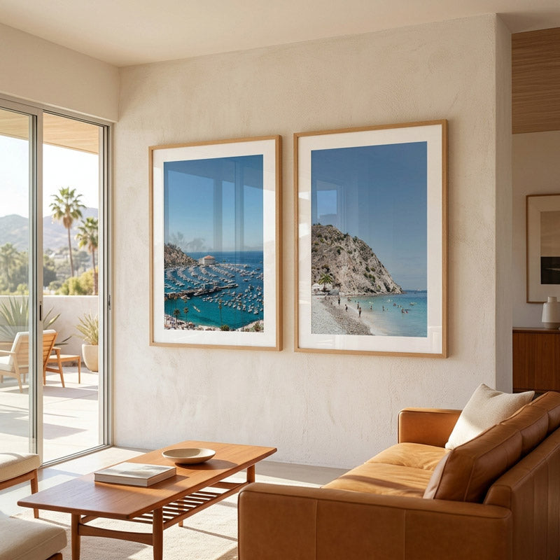 Living room with two framed beach scenes on a wall, wooden coffee table, and brown sofa.