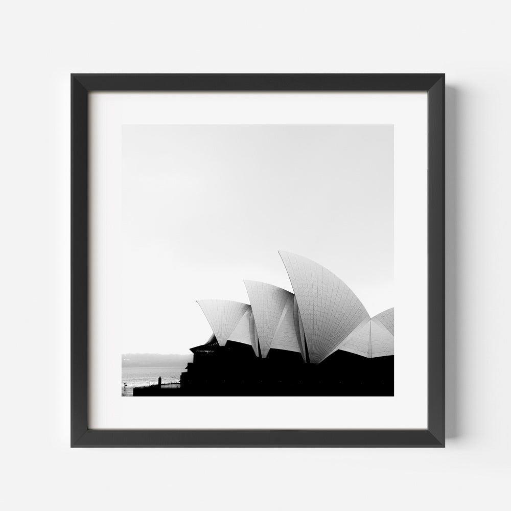 Framed black and white image of the Sydney Opera House with the sea in the background, adding sophistication to your wall decor.