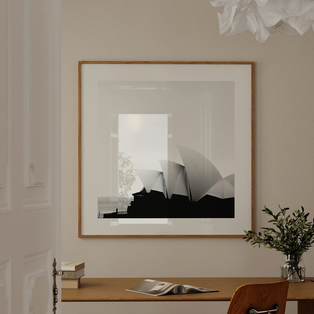 Captivating black and white framed photograph of the Opera House against the sea backdrop, ideal for modern home decor.