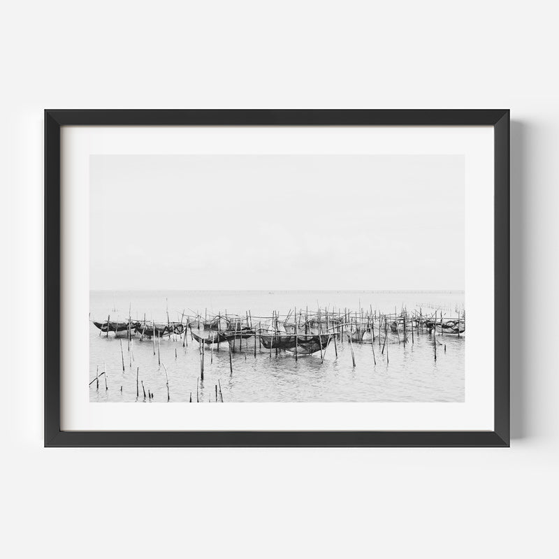 Framed black and white photograph of fishing nets on water