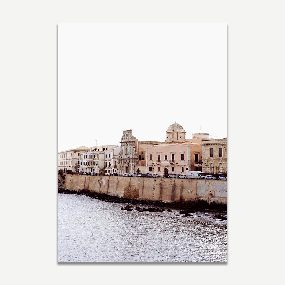Framed coastal wall art featuring muted pastel buildings along the Syracuse, Sicily waterfront—Mediterranean architecture with a soft, beach-inspired colour palette.