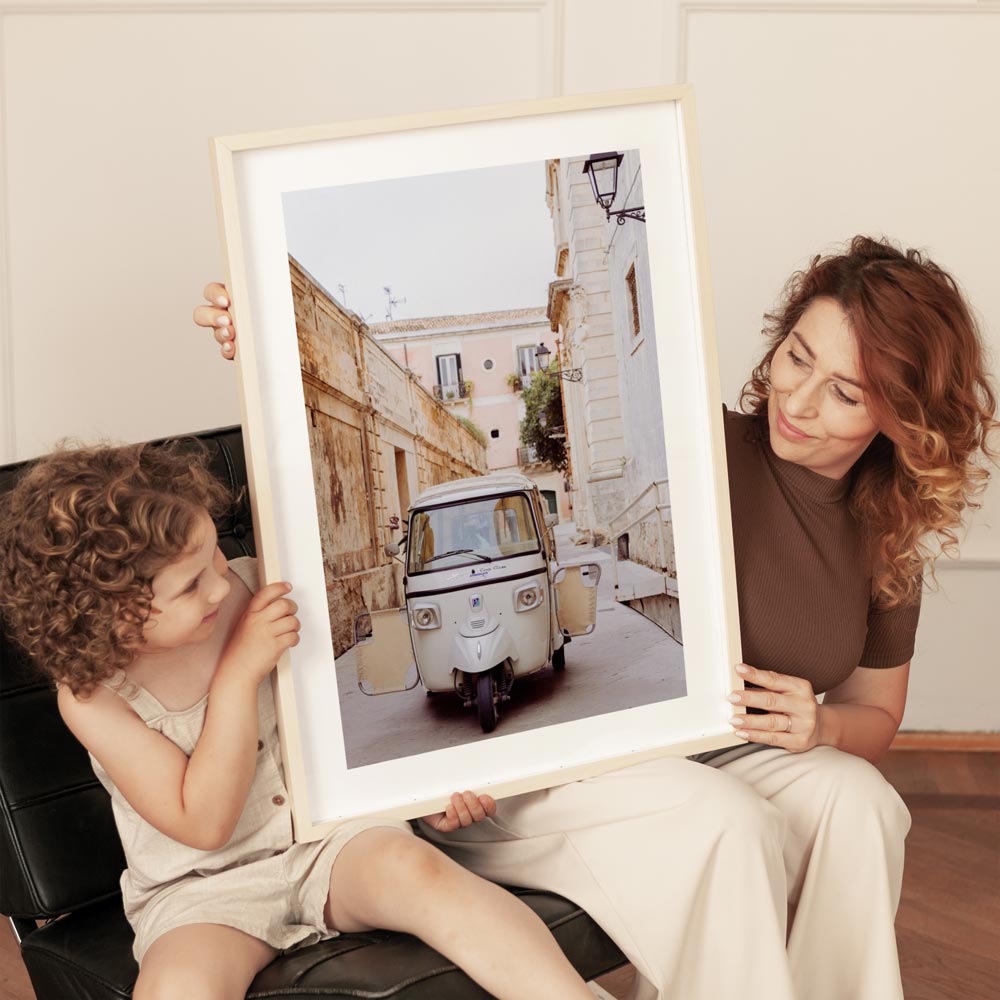 Tuk tuk vehicle parked on a quiet street in Syracuse, Sicily, captured in muted neutral tones – framed coastal wall art perfect for travel-inspired beach decor.
