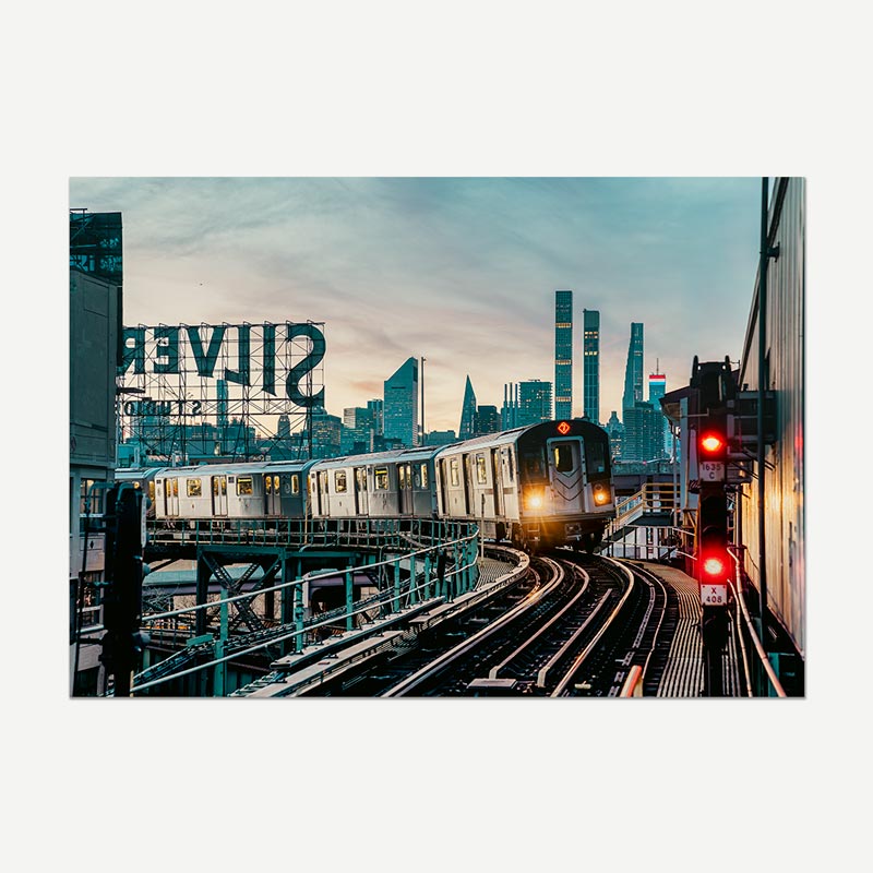 Cityscape with a train on tracks and skyline, featuring a large 'Silver' sign.