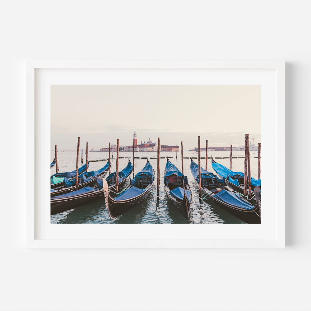 Experience the charm of Venice with this captivating photograph of boats along the poles - ideal for wall art enthusiasts.
