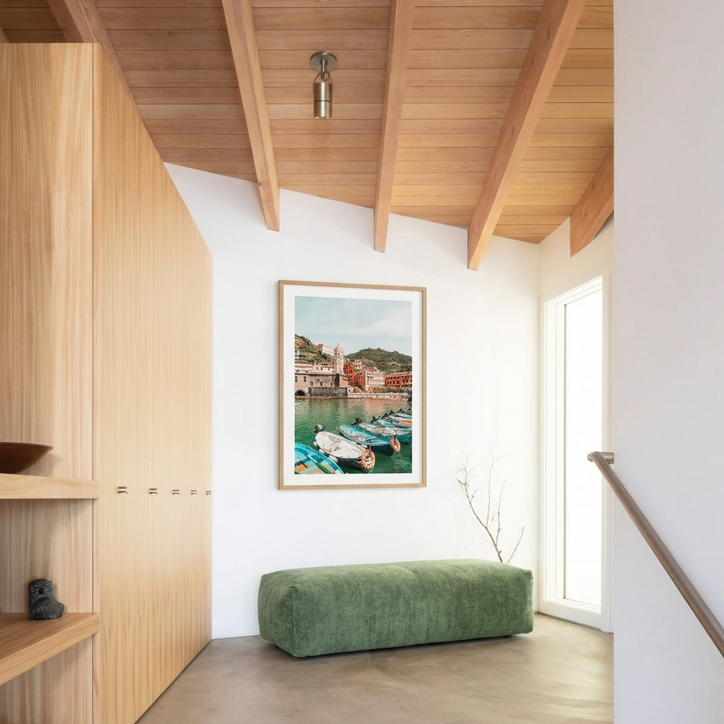 Modern interior with wooden walls, a green bench, and a framed picture of a harbor.