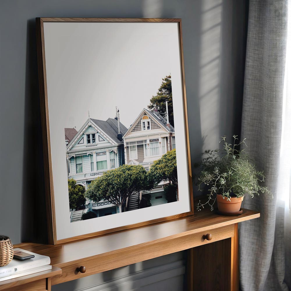 Framed art print of San Francisco’s Painted Ladies, highlighting historic homes with the city’s skyline in the background.