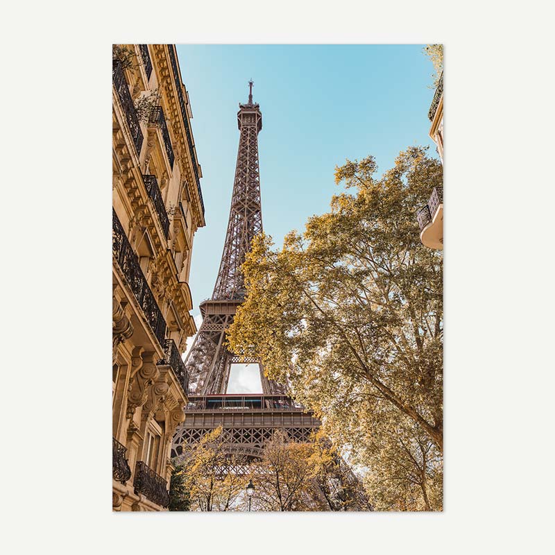 Eiffel Tower with trees and building facades in Paris