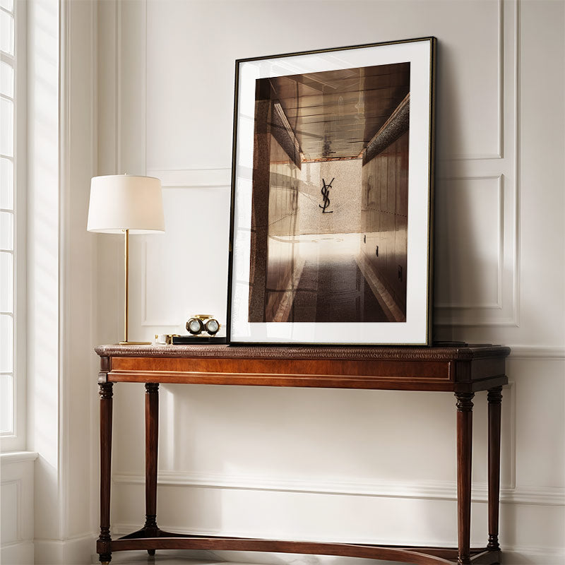 Wooden console table with a framed photograph on a white wall