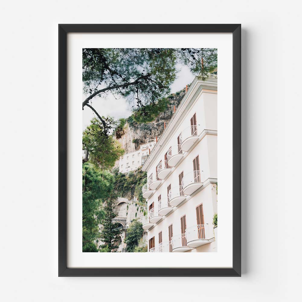 Italian Amalfi hotel building photo in white frame sold by Oblongshop, specializing in wall art for homes and offices worldwide.
