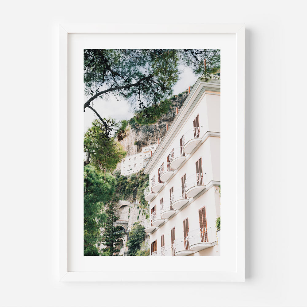 A white framed photo of Amalfi hotel building in Italy, part of Oblongshop's collection of wall art from around the world