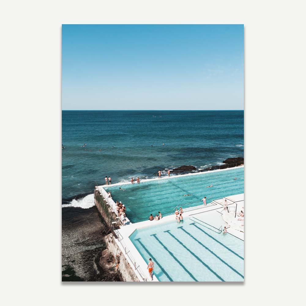Vibrant Bondi Icebergs Pool wall art with blue tones and beachgoers – perfect coastal decor for a relaxed, beach-inspired home.