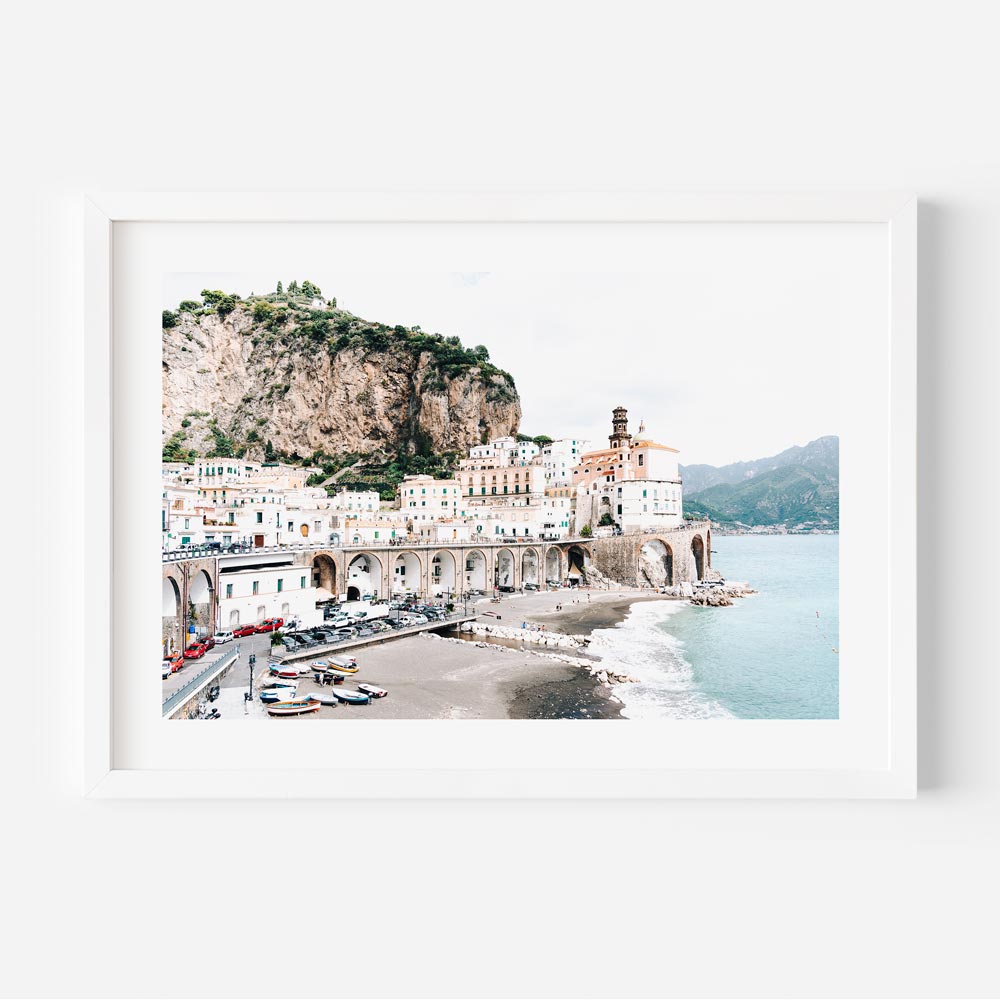 A framed photo of a beach and mountain, perfect for wall art decor in homes and offices.