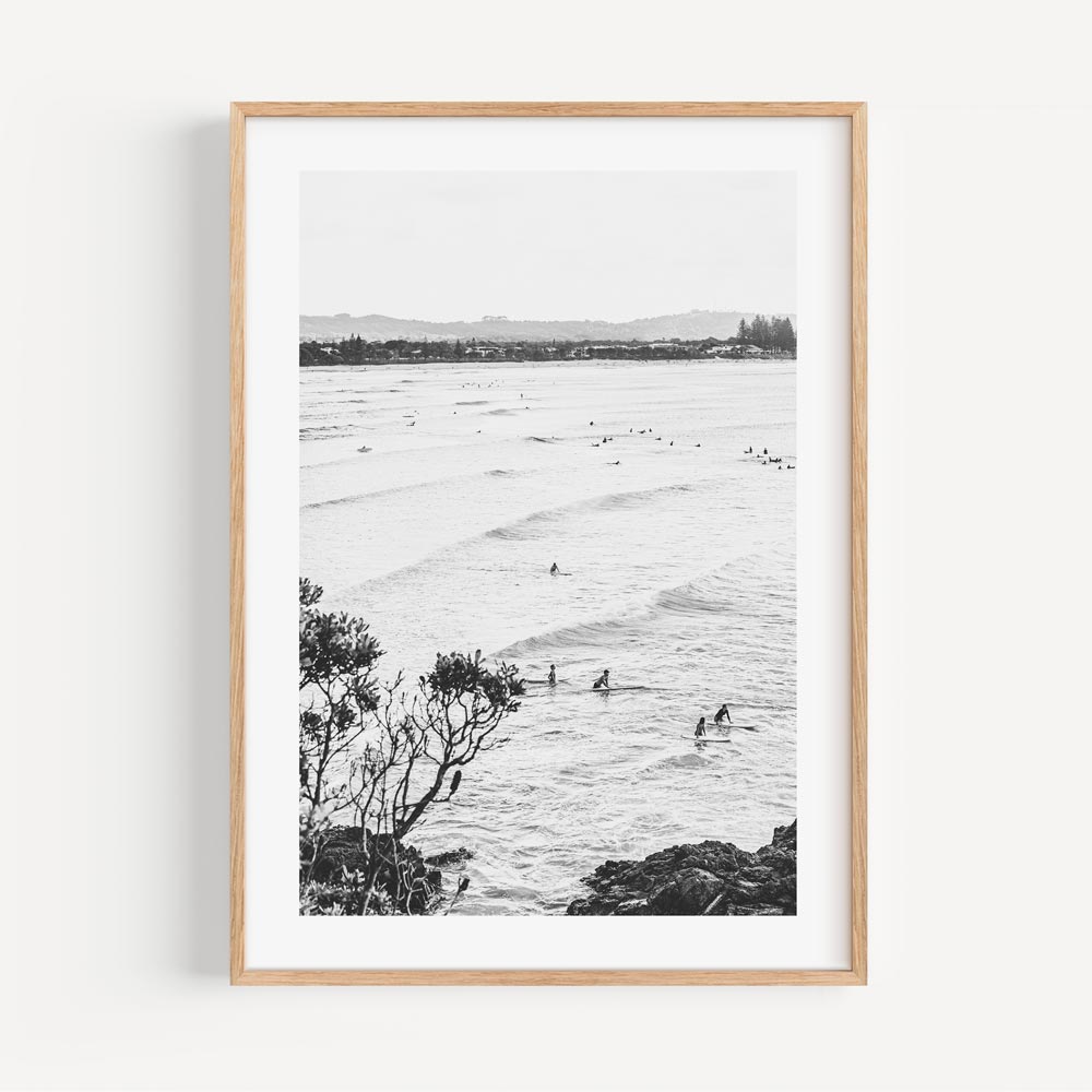 Stunning black and white photo of surfers in the ocean at THE PASS, BYRON BAY. Unique wall artwork for your space at Oblongshop.
