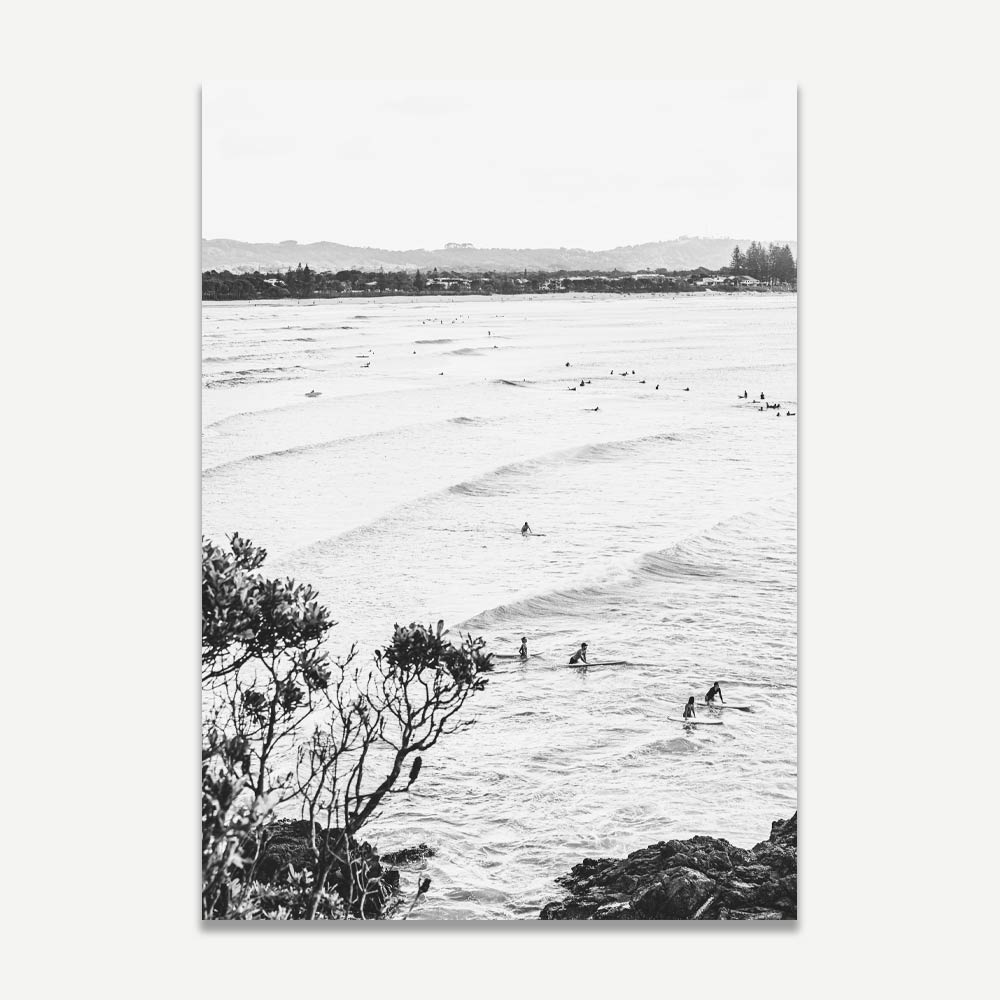 Serene black and white image of surfers in the ocean at THE PASS, BYRON BAY. Elevate your space with this elegant wall art from Oblongshop.