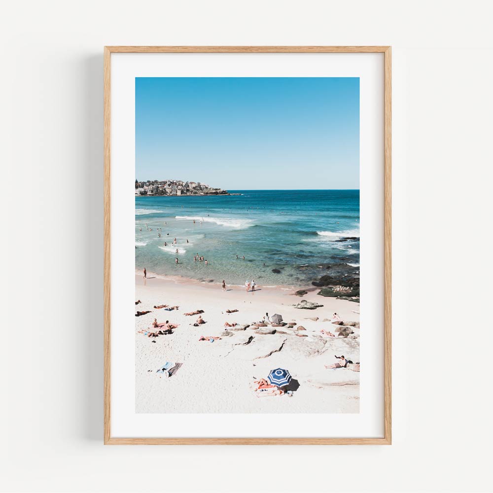 A serene golden framed photo capturing people swimming on Bondi Beach - a must-have for art enthusiasts and beach lovers alike.