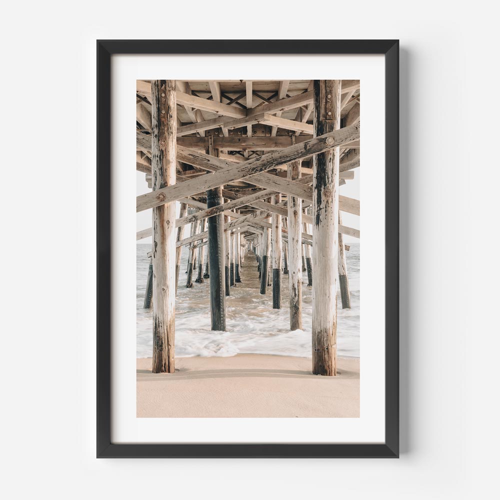 Framed beach wall art of California pier with serene shoreline