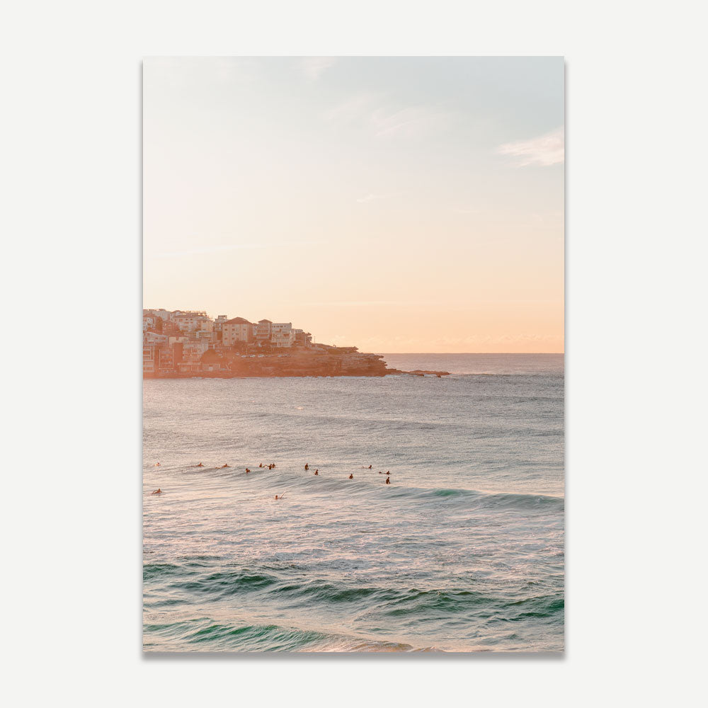 The wall art of surfers gliding on the water in the morning at Bondi beach. The best seller of Bondi beach print and must-have for your home decor if you need to bring the coastal feels to your interior space.