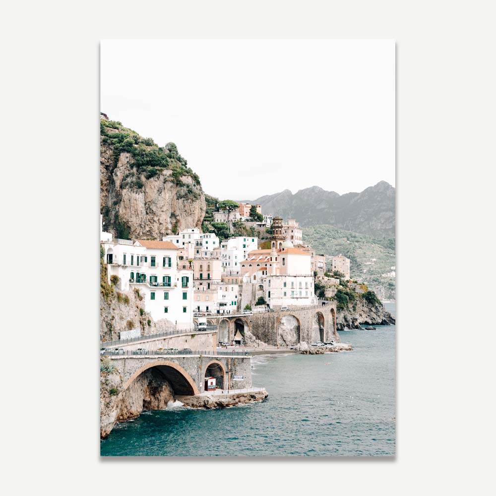 Wall art of colorful cliffside houses in Atrani on the Amalfi Coast, showcasing Mediterranean charm. Transform your walls with coastal elegance and scenic mountain backdrops.