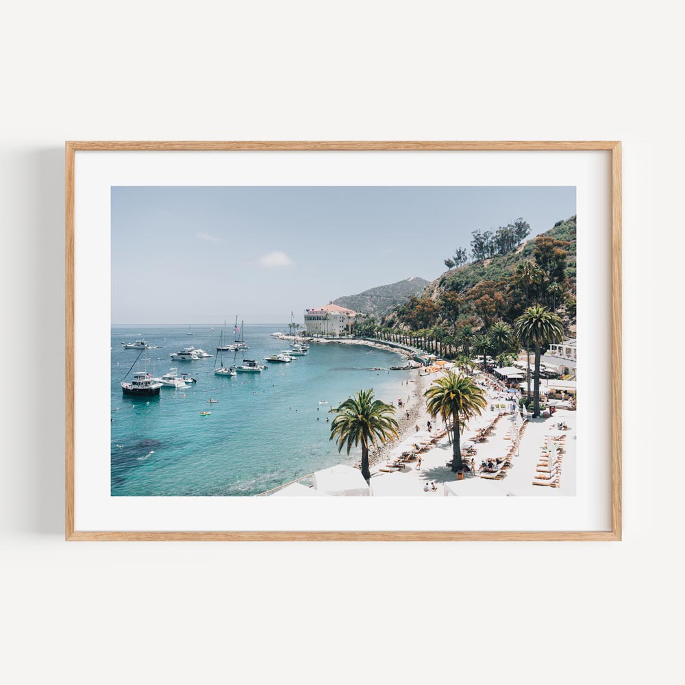 Beautiful wall art print of a beach with palm trees and boats, perfect for adding a cool touch to any room.