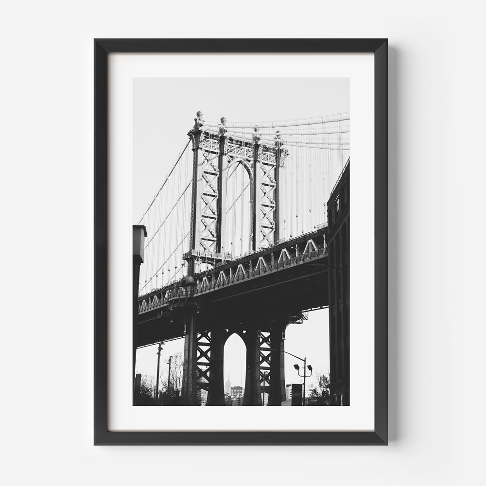 Brooklyn's Landmark: Dumbo Bridge captured in a striking black and white frame, suitable for prints shop collections.